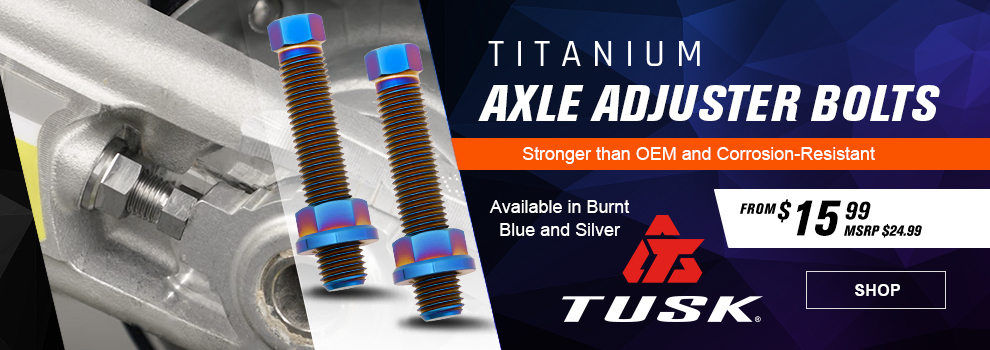 Tusk Titanium Axle Adjuster Bolts, Stronger than OEM and Corrosion-Resistant, From $15 and 99 cents, MSRP $24 and 99 cents, the silver adjuster bolt in the swingarm of a dirt bike, a closeup of the burnt blue axle bolts, link, shop